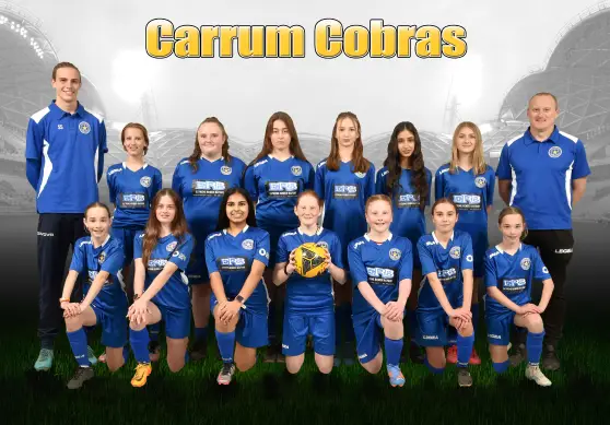 Carrum Cobras youth soccer team and coaches posing together in blue uniforms.