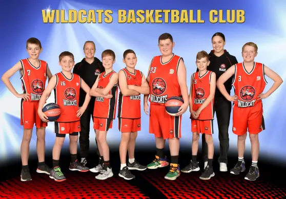 Wildcats Basketball Club junior team posing together in red uniforms.